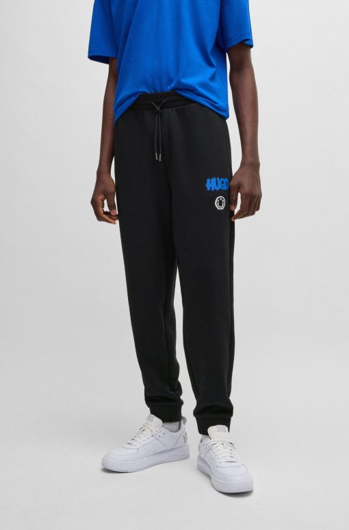 Hugo Boss Sweatshirts and Jogging Pants-Cotton-terry tracksuit bottoms with Happy HUGO logo-hugo by hugo boss